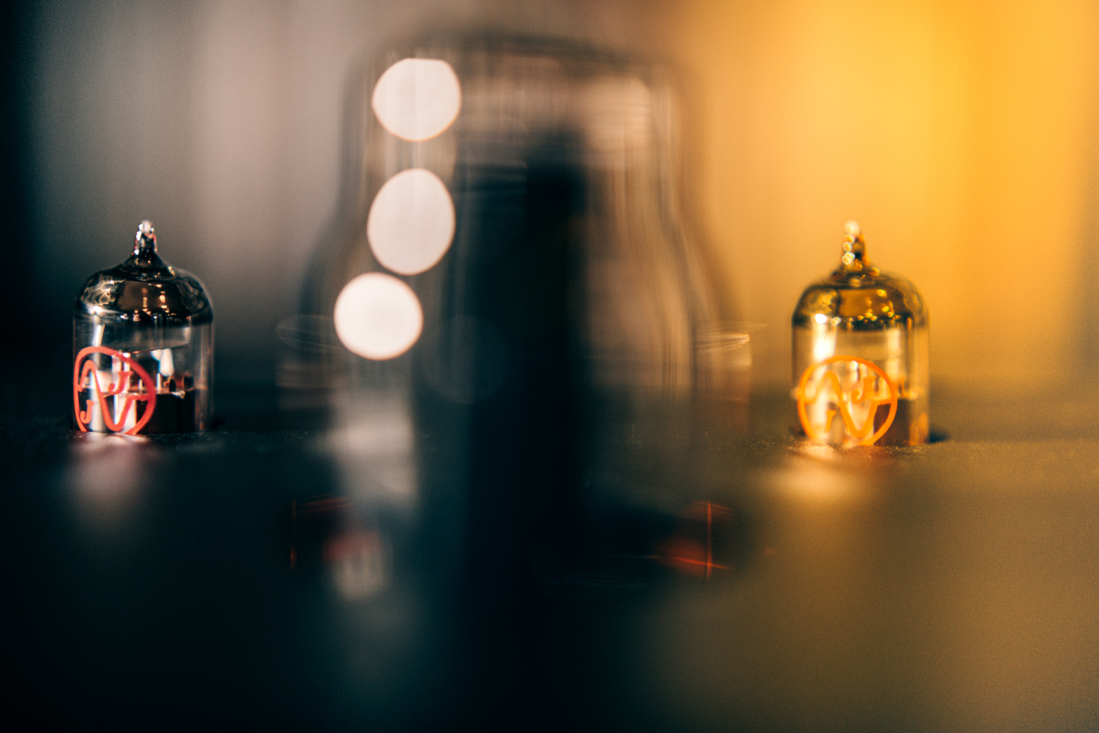 ModWright tube amplifier glowing at Kissa Kissa — handmade American tube amp powering Harbeth speakers