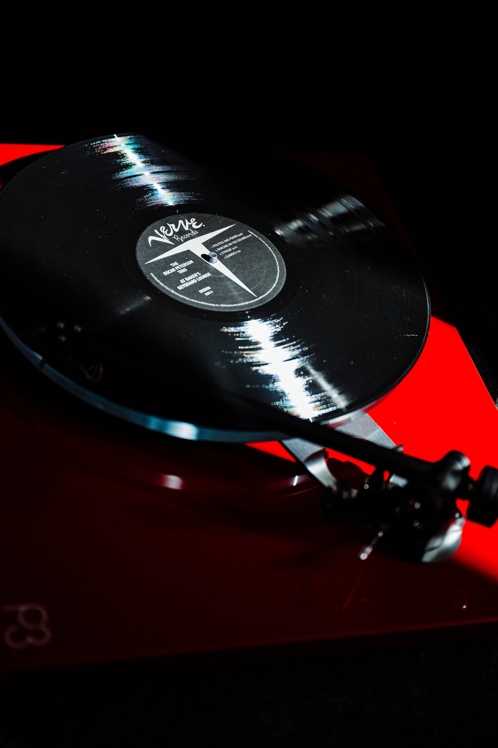 A Verve Records LP spinning on the red Technics SL-1200GR turntable at Kissa Kissa under low jazz kissa lighting