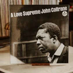 John Coltrane A Love Supreme album cover displayed on table with record stacks at Kissa Kissa Crown Heights Brooklyn