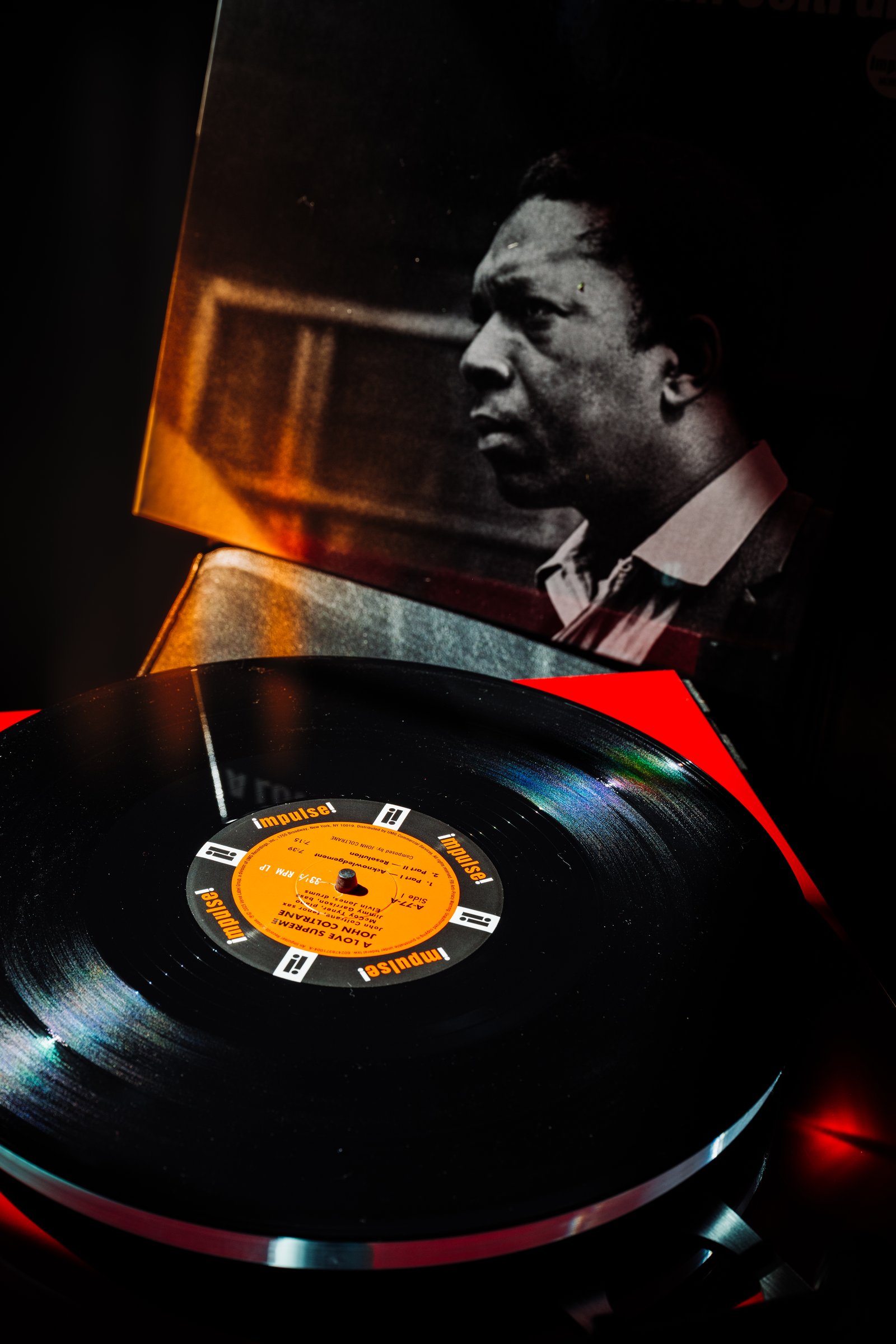 A Love Supreme mono pressing on the red Technics turntable at Kissa Kissa with album cover behind