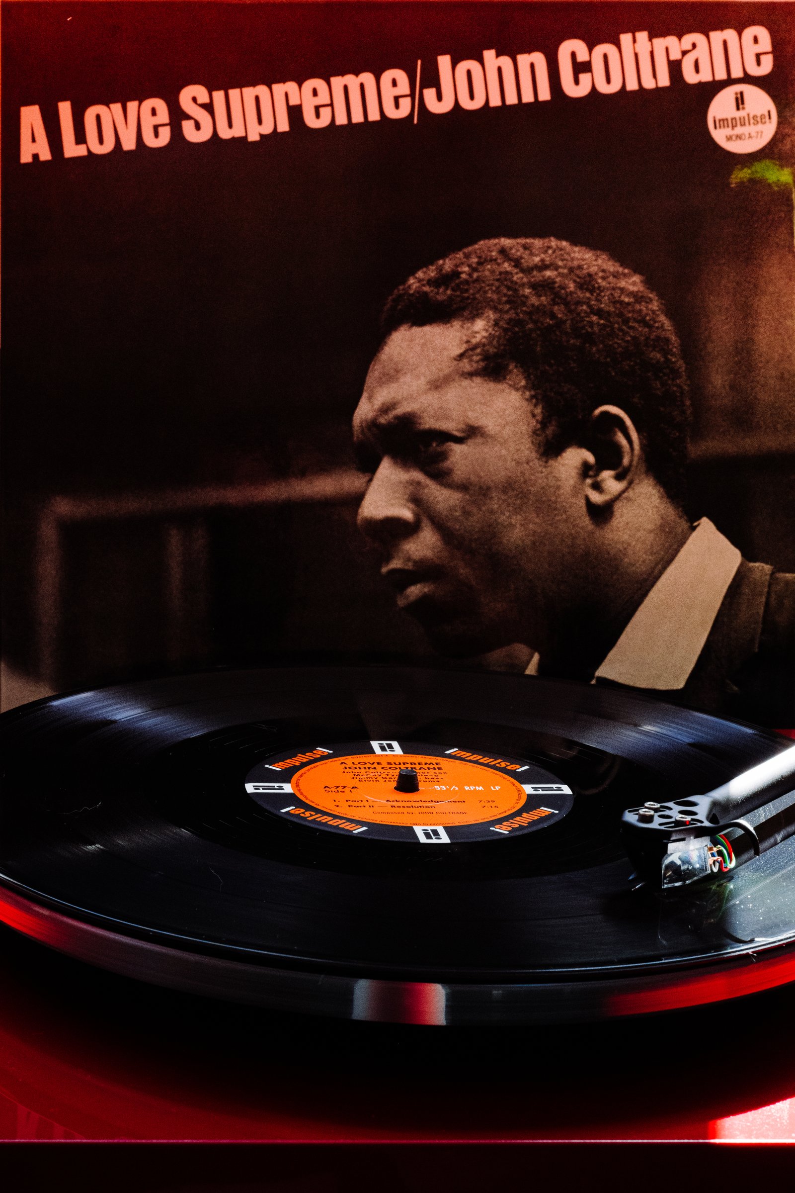 A Love Supreme album cover with Impulse Records mono LP on red turntable at Kissa Kissa