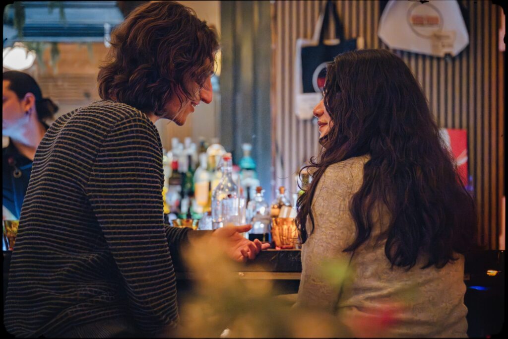 Two guests talking at the bar at Kissa Kissa