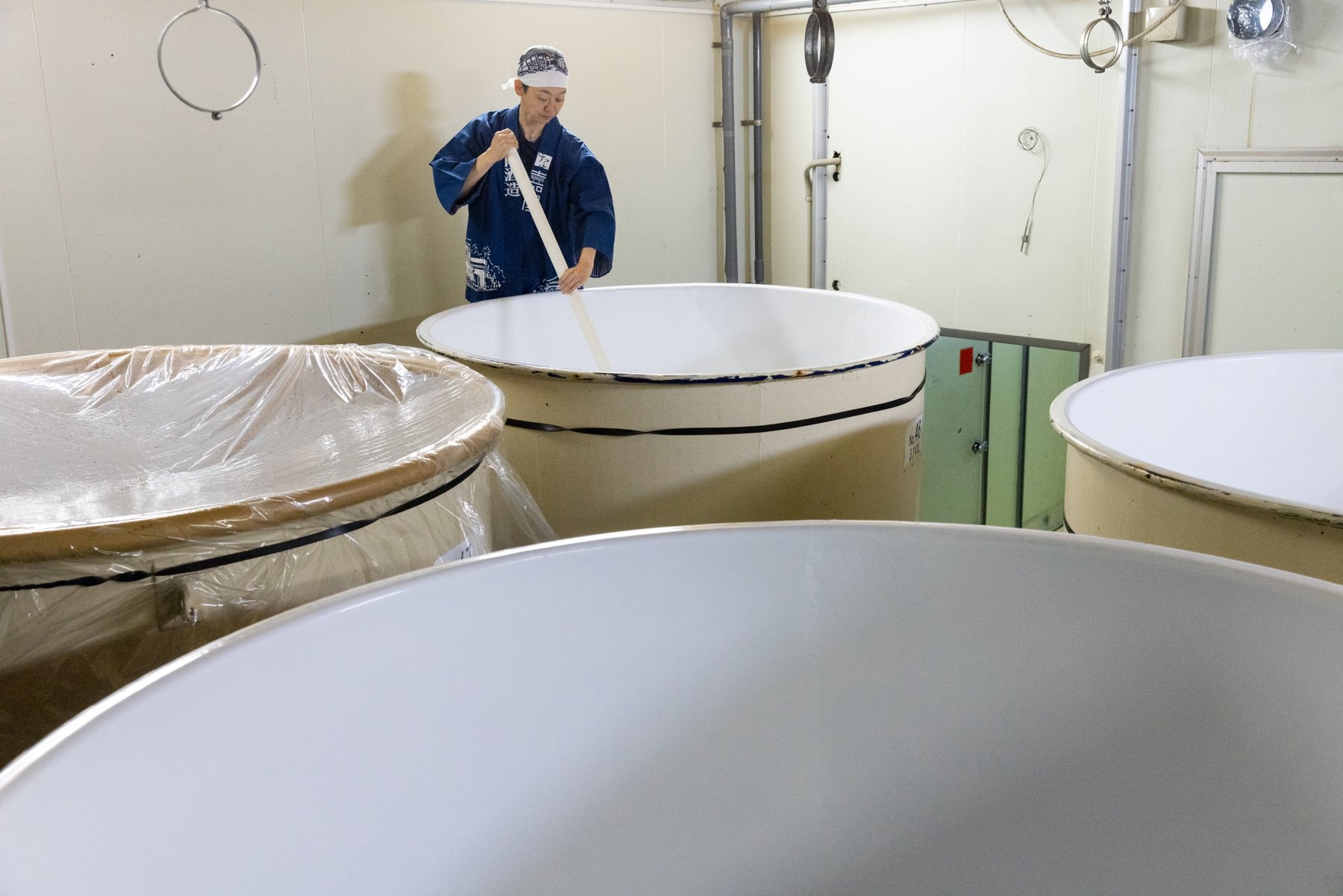 A brewer stirring sake tanks at Kiuchi Brewery, home of Hitachino Nest